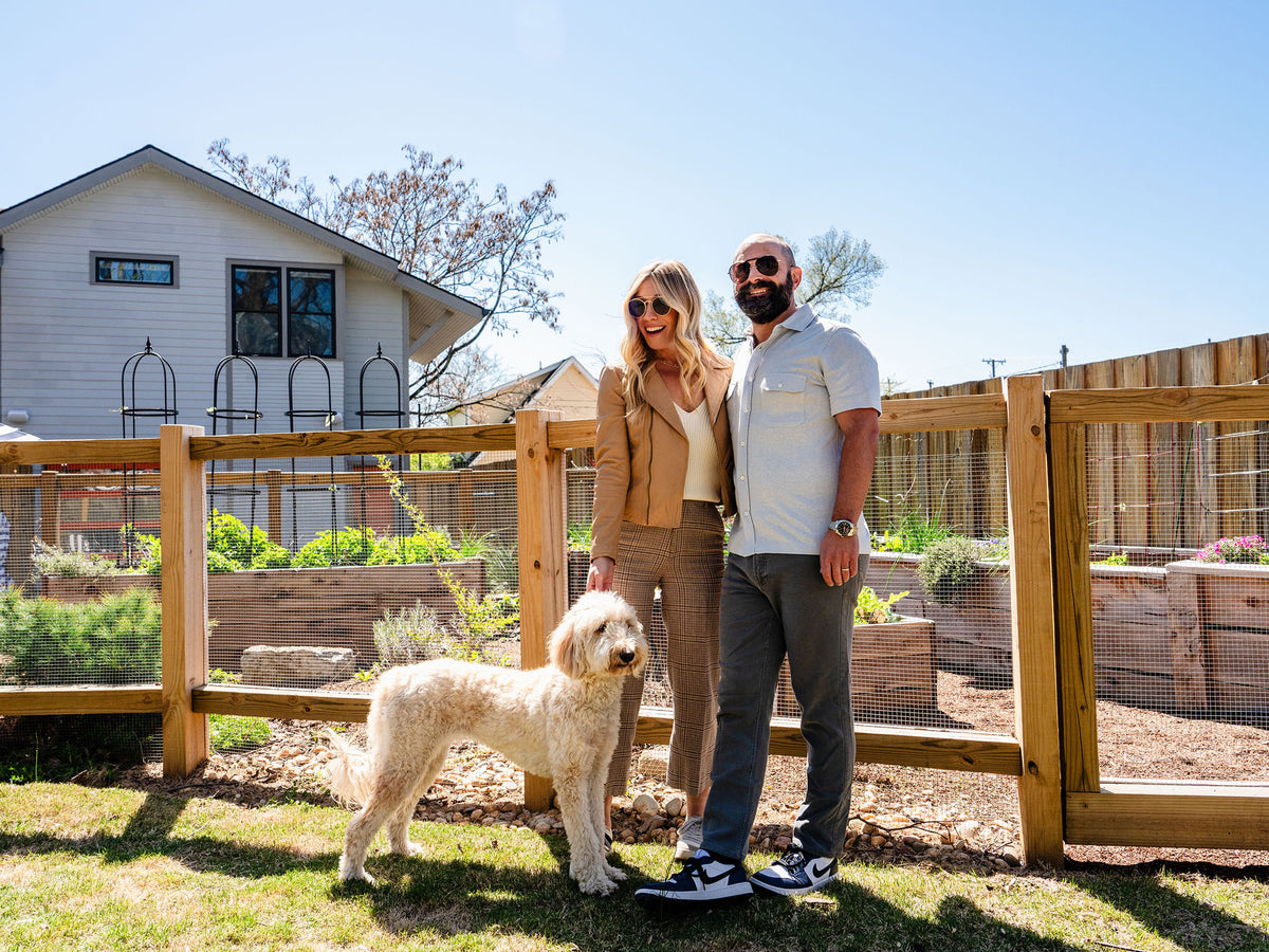 The Holcombs smile with their dog.