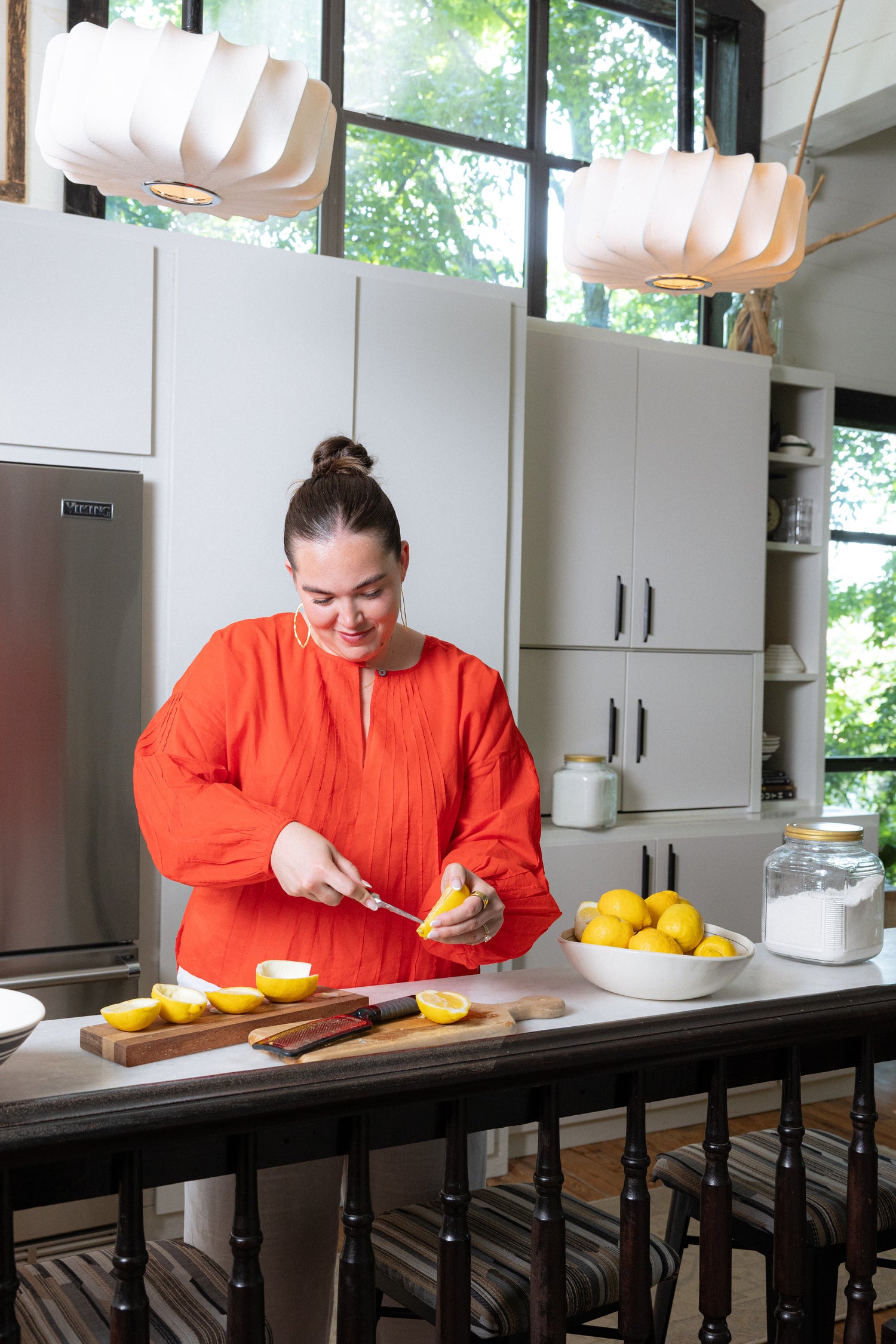 Billy's daughter Abba scoops the insides of a lemon while preparing her Lemon Posset dessert.
