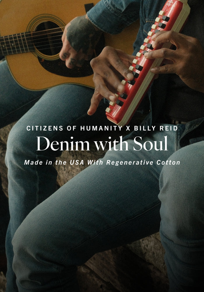Person playing guitar with denim jeans, featuring 'Citizens of Humanity x Billy Reid' branding.