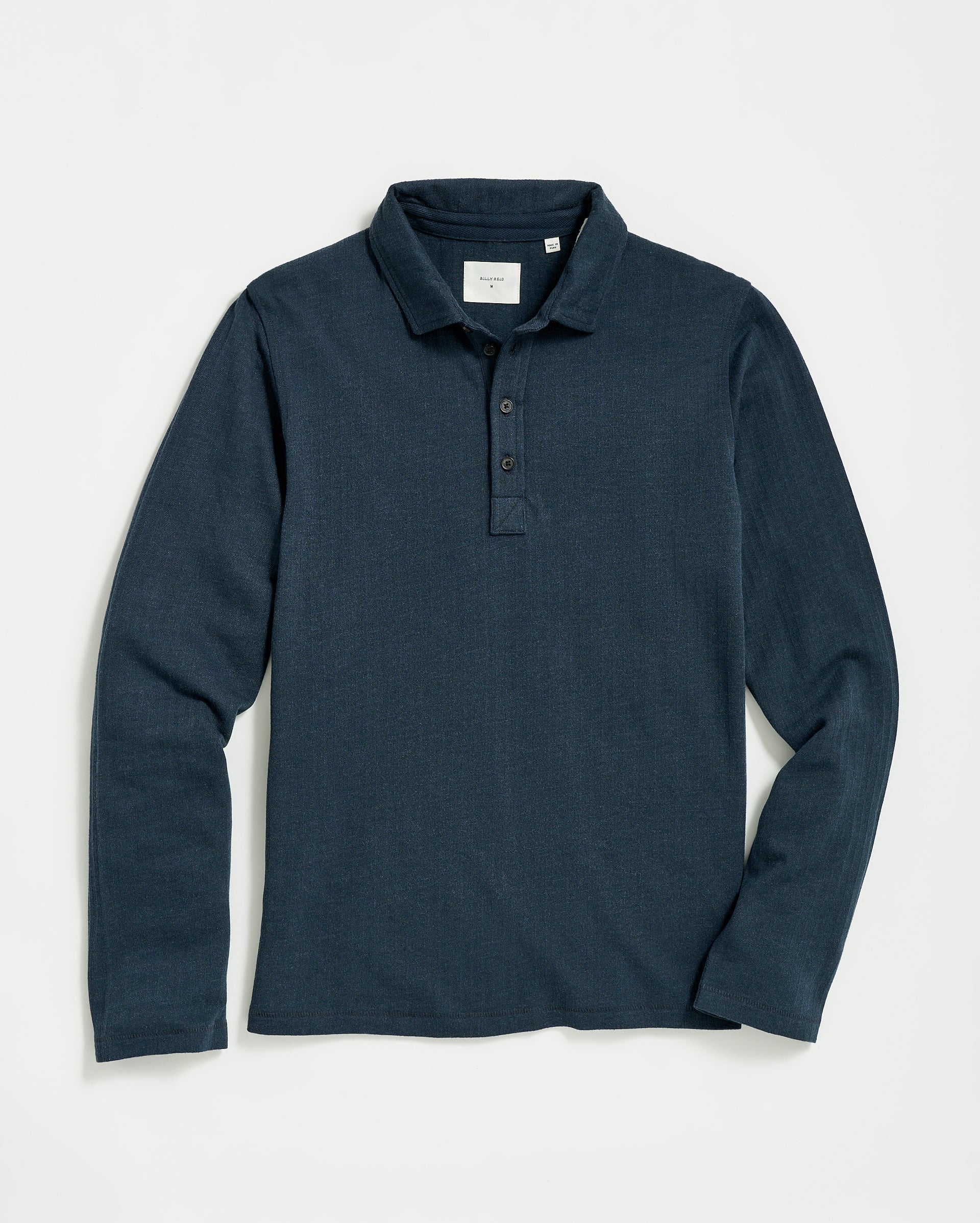 A long-sleeve, dark blue polo shirt with a collar and three buttons at the neckline, laid flat on a white background.