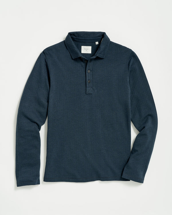 A long-sleeve, dark blue polo shirt with a collar and three buttons at the neckline, laid flat on a white background.