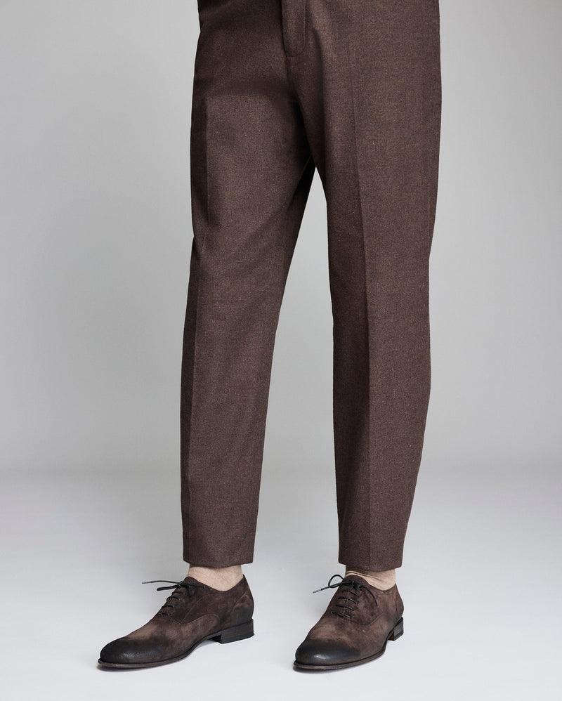 Brown dress pants worn by a person on a light gray background Alternate
