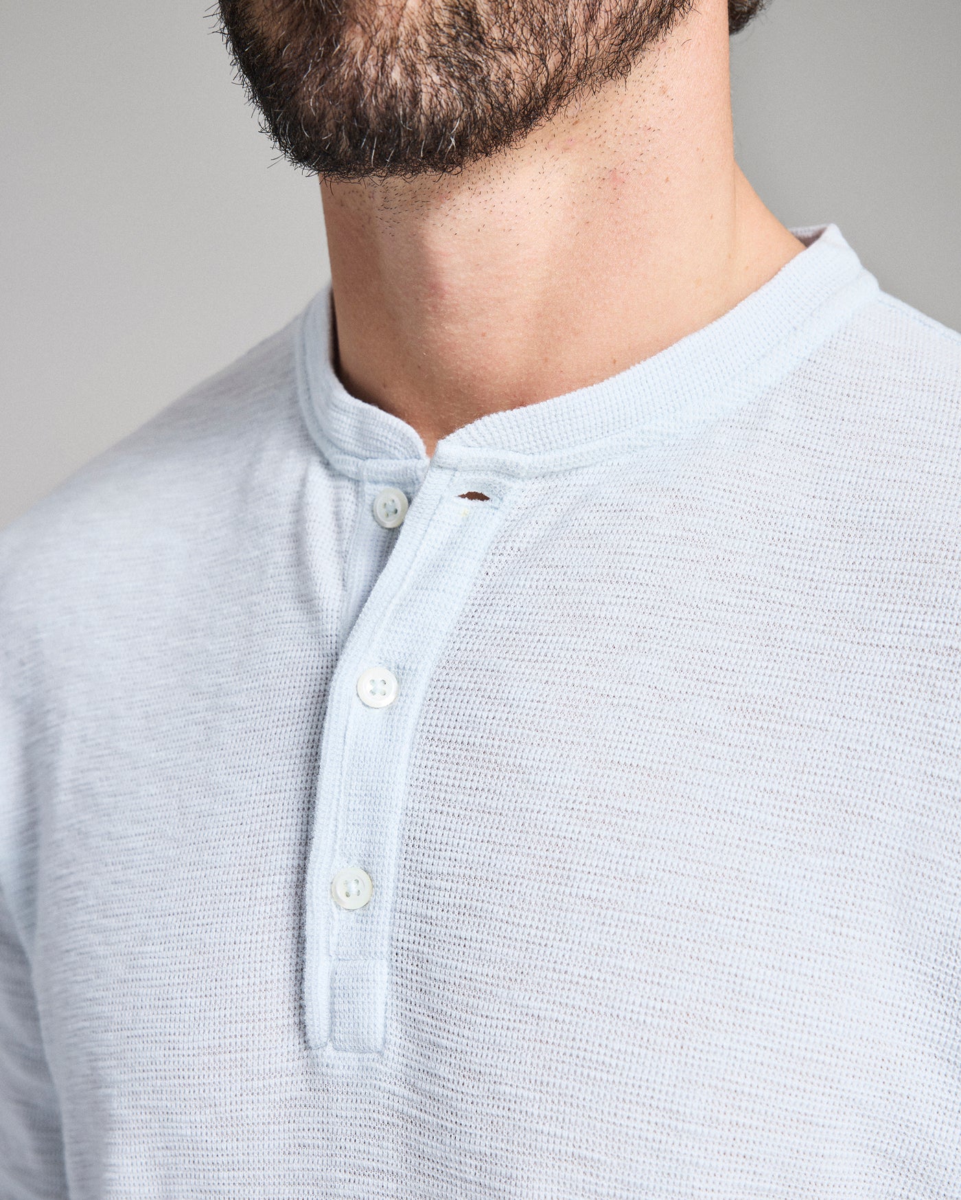 Light blue button-up shirt worn by a person with a neutral background