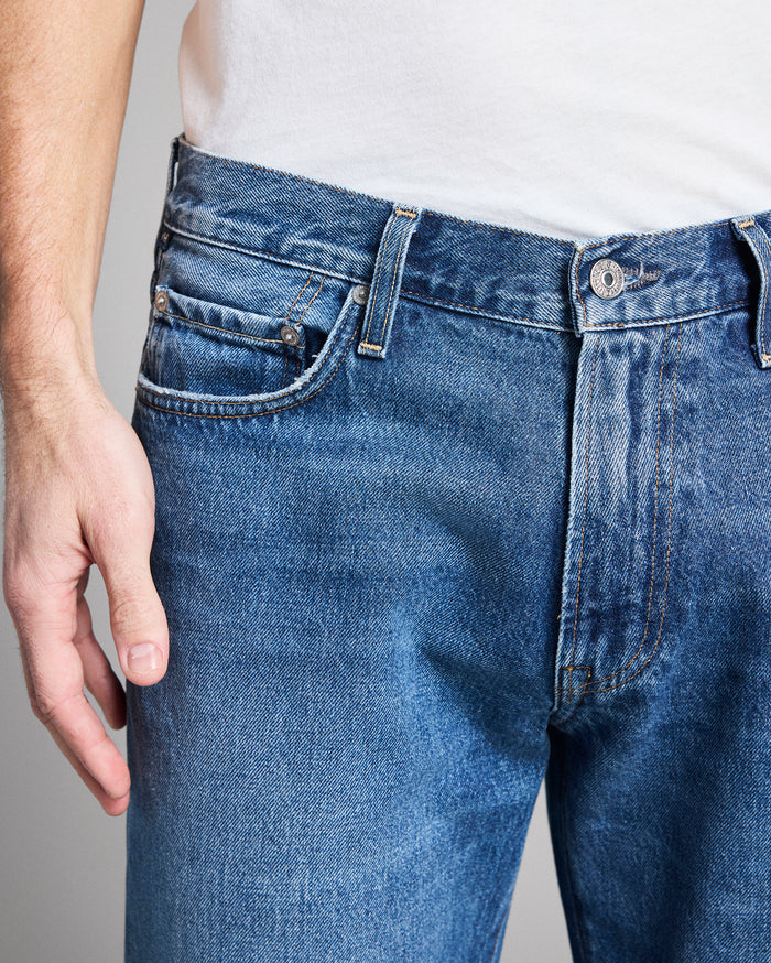 Close-up of blue jeans with a neutral background