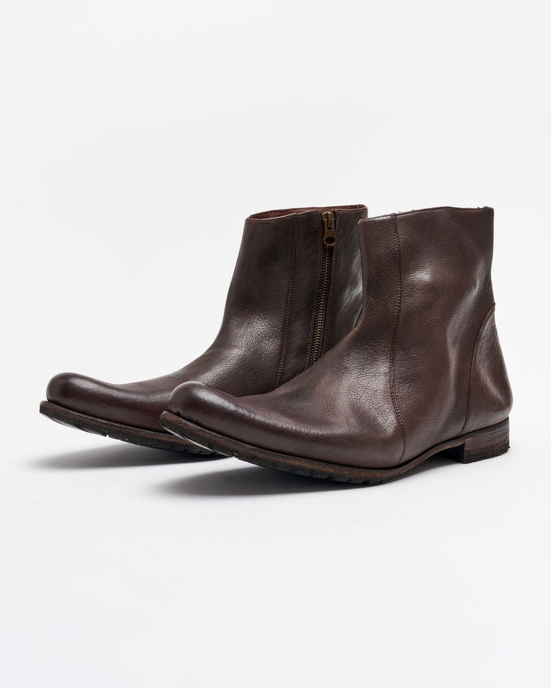A pair of dark brown leather ankle boots with side zippers and low heels, displayed on a plain white background.