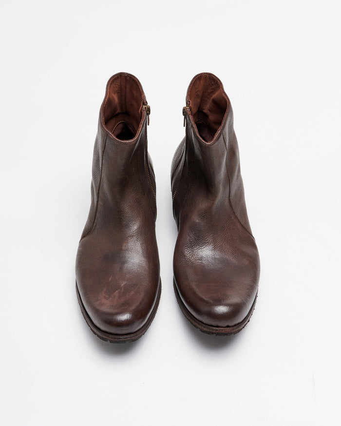 A pair of brown leather ankle boots with zippers on the sides, viewed from above on a plain white background.