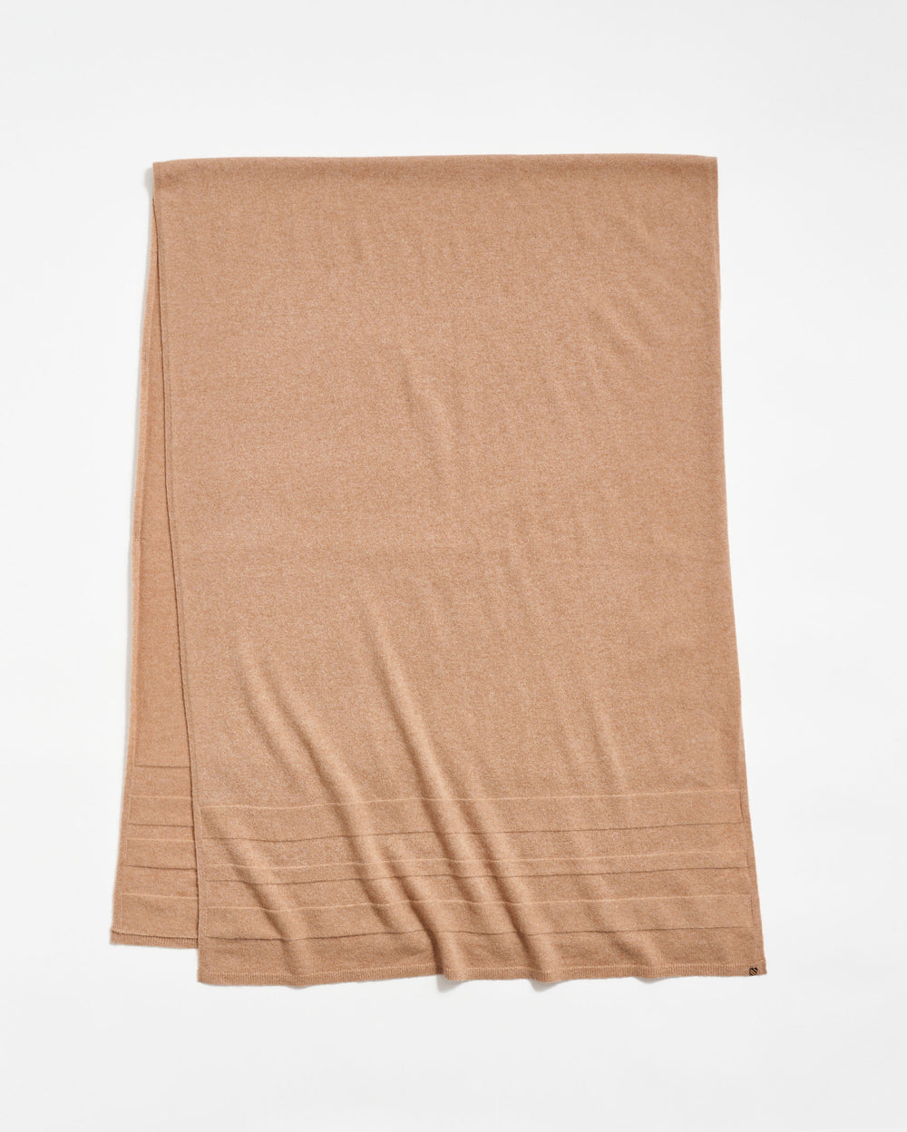 A light brown rectangular scarf is laid flat on a white background, featuring subtle horizontal ribbed lines near one end.