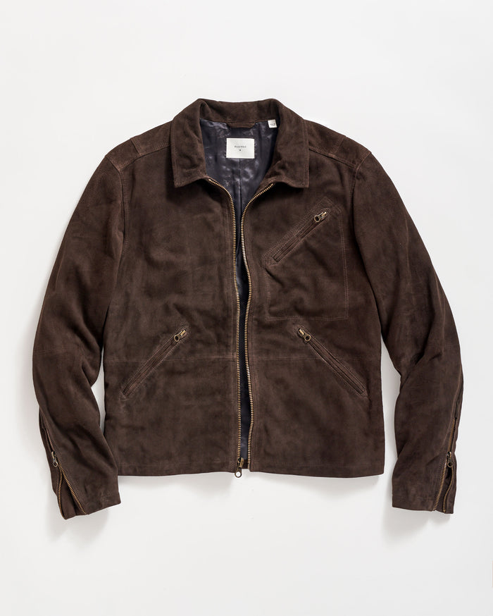 A brown suede jacket with a front zipper, two zippered side pockets, one zippered chest pocket, and zippered cuffs, laid flat on a white background.