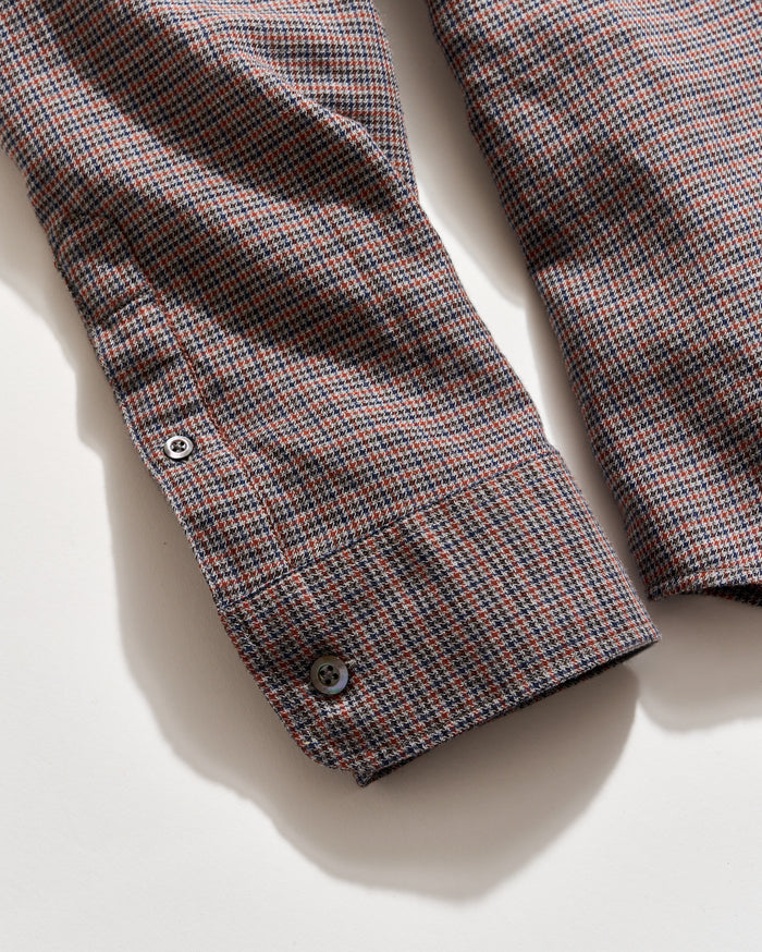 Plaid shirt with a button on a light background