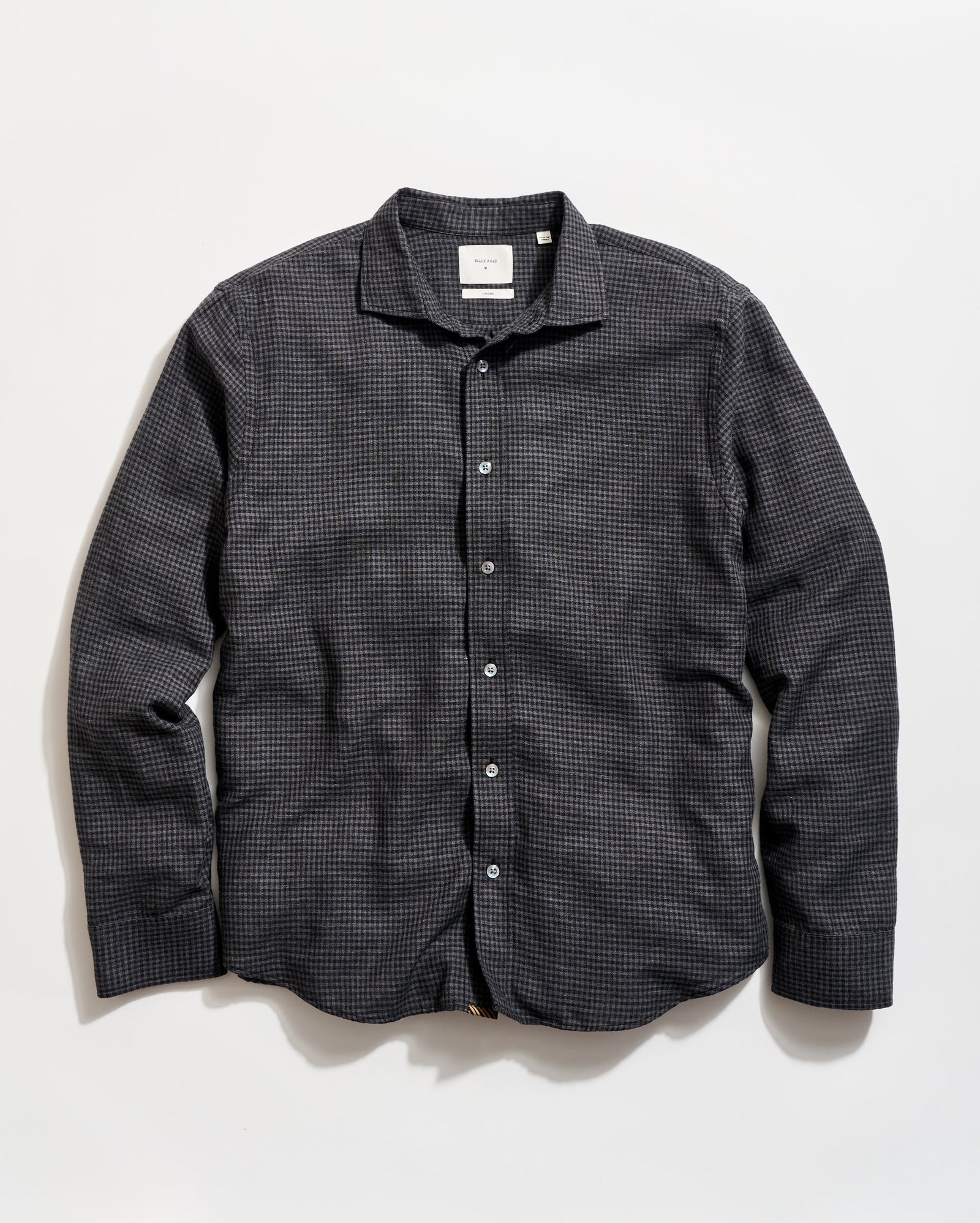 Black checkered shirt on a light beige background