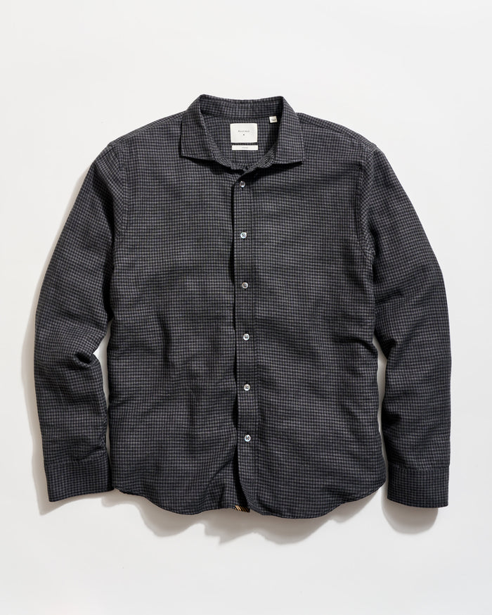 Black checkered shirt on a light beige background