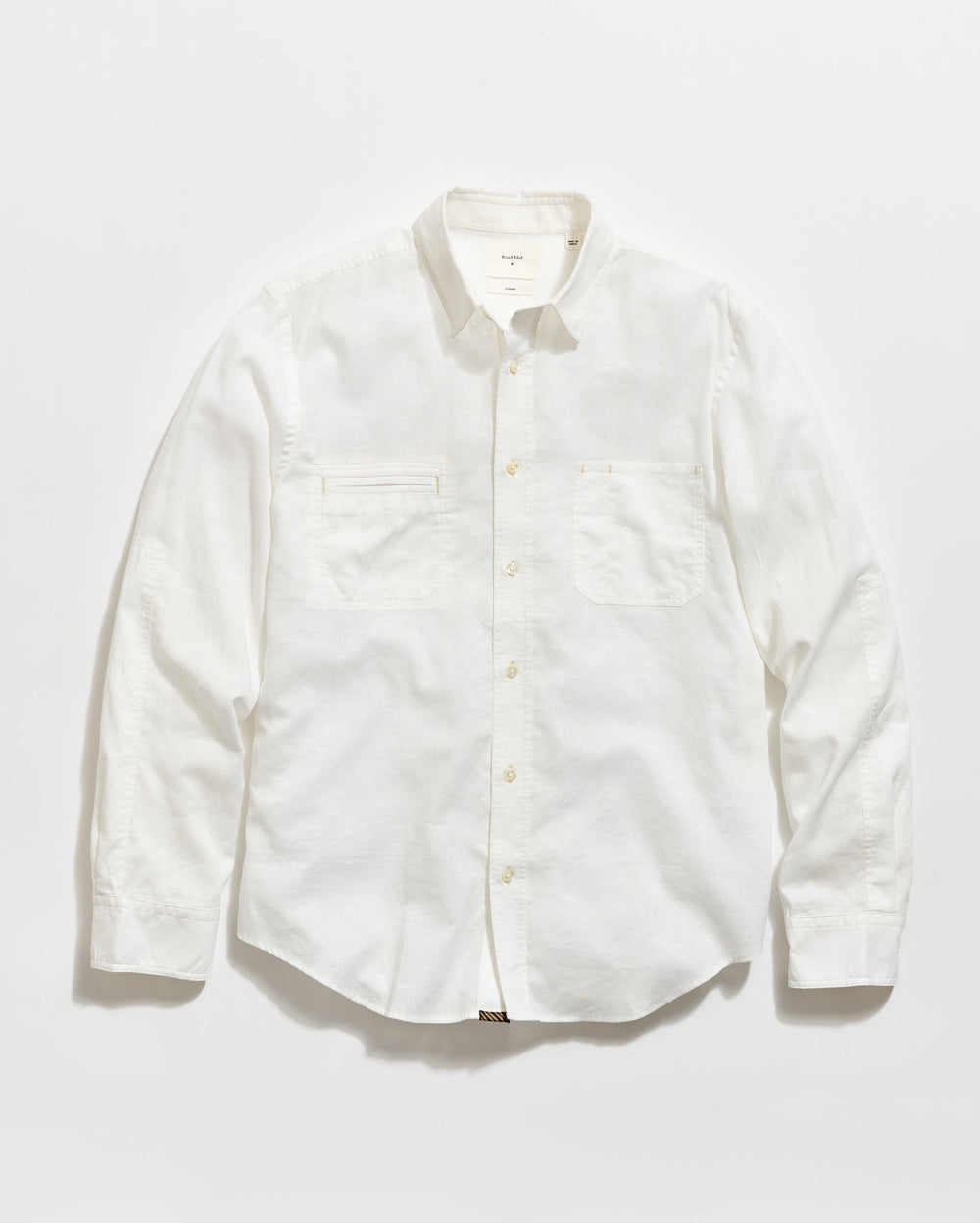 A long-sleeve, button-up white shirt with a collar and two chest pockets, laid flat on a plain white background.