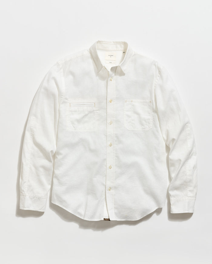 A long-sleeve, button-up white shirt with a collar and two chest pockets, laid flat on a plain white background.