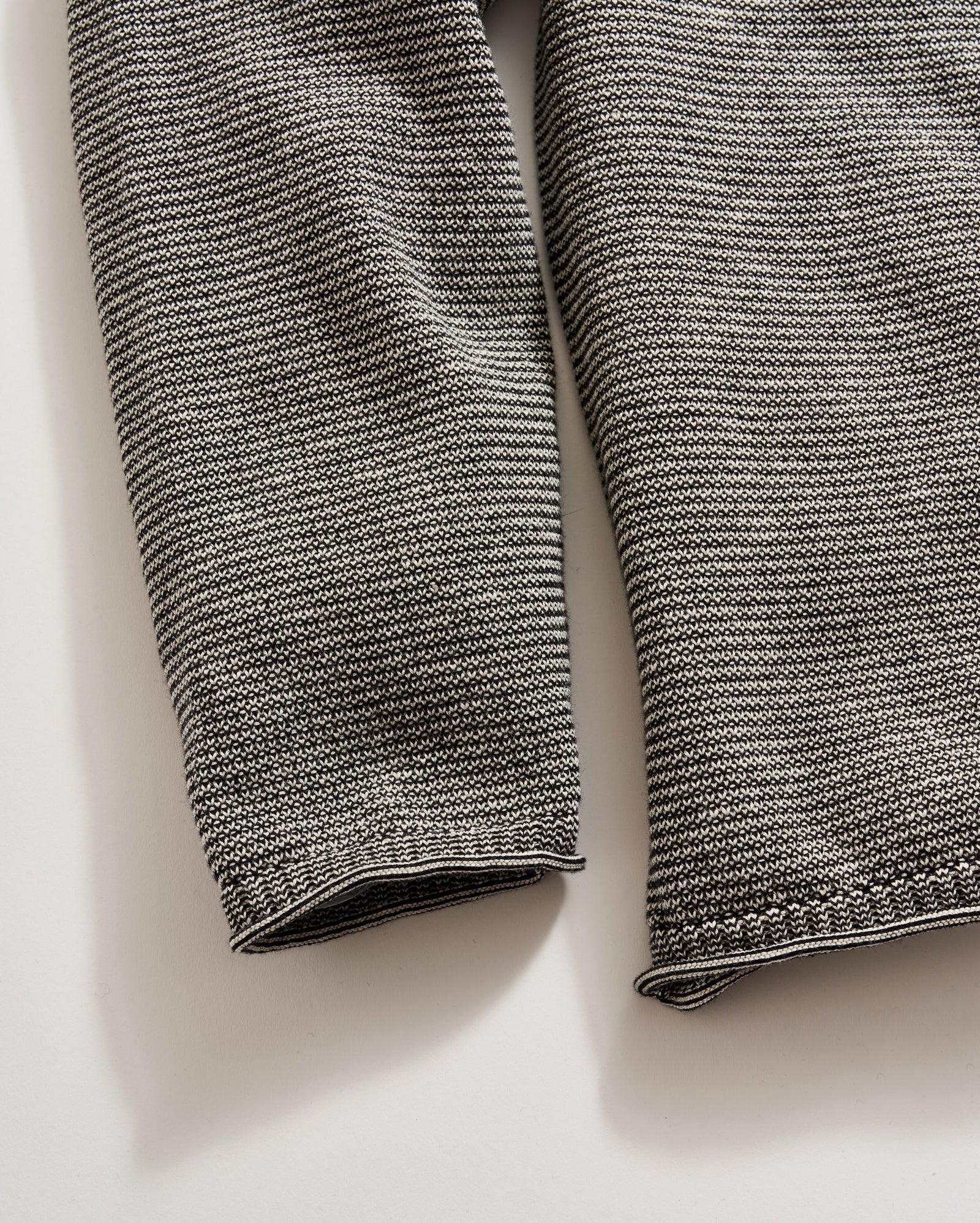 Close-up of a textured gray fabric on a light beige background