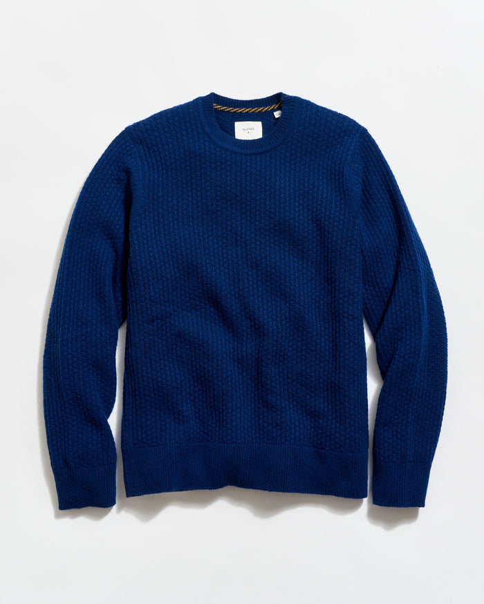 Blue sweater on a light gray background