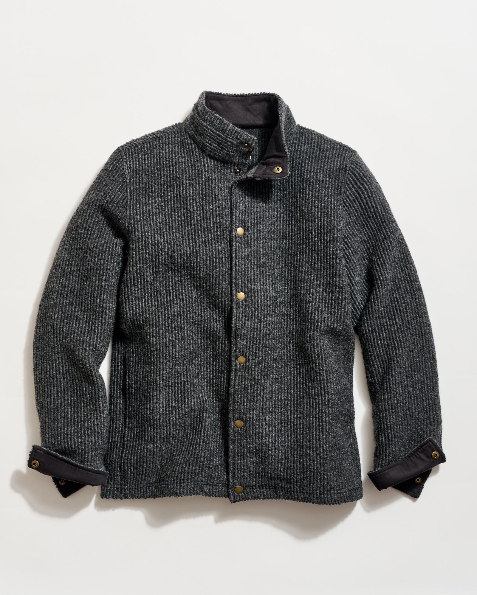 Gray textured jacket with button details on a light gray background