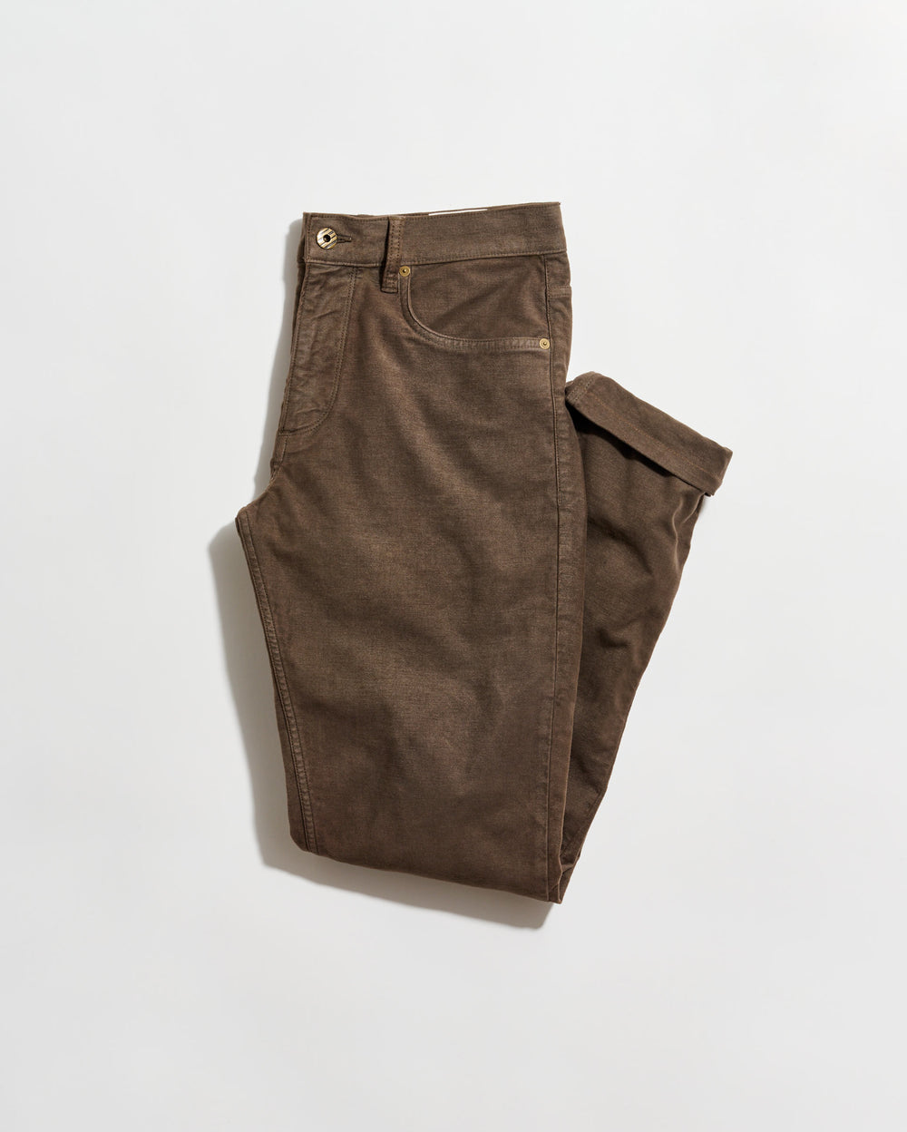 A pair of brown pants neatly folded on a plain white background. The pants have front and back pockets, belt loops, and a button closure at the waist.