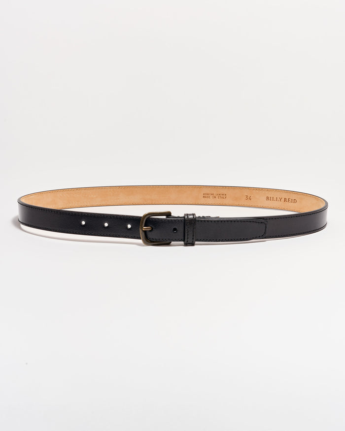 A black leather belt with a matte silver buckle is laid flat on a white background. The belt interior is tan, and size and brand details are stamped on the inside.