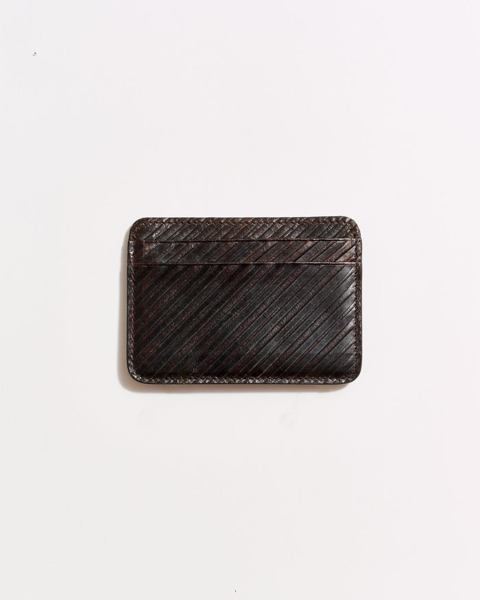 A dark brown leather cardholder with diagonal stitching, placed on a plain white background.