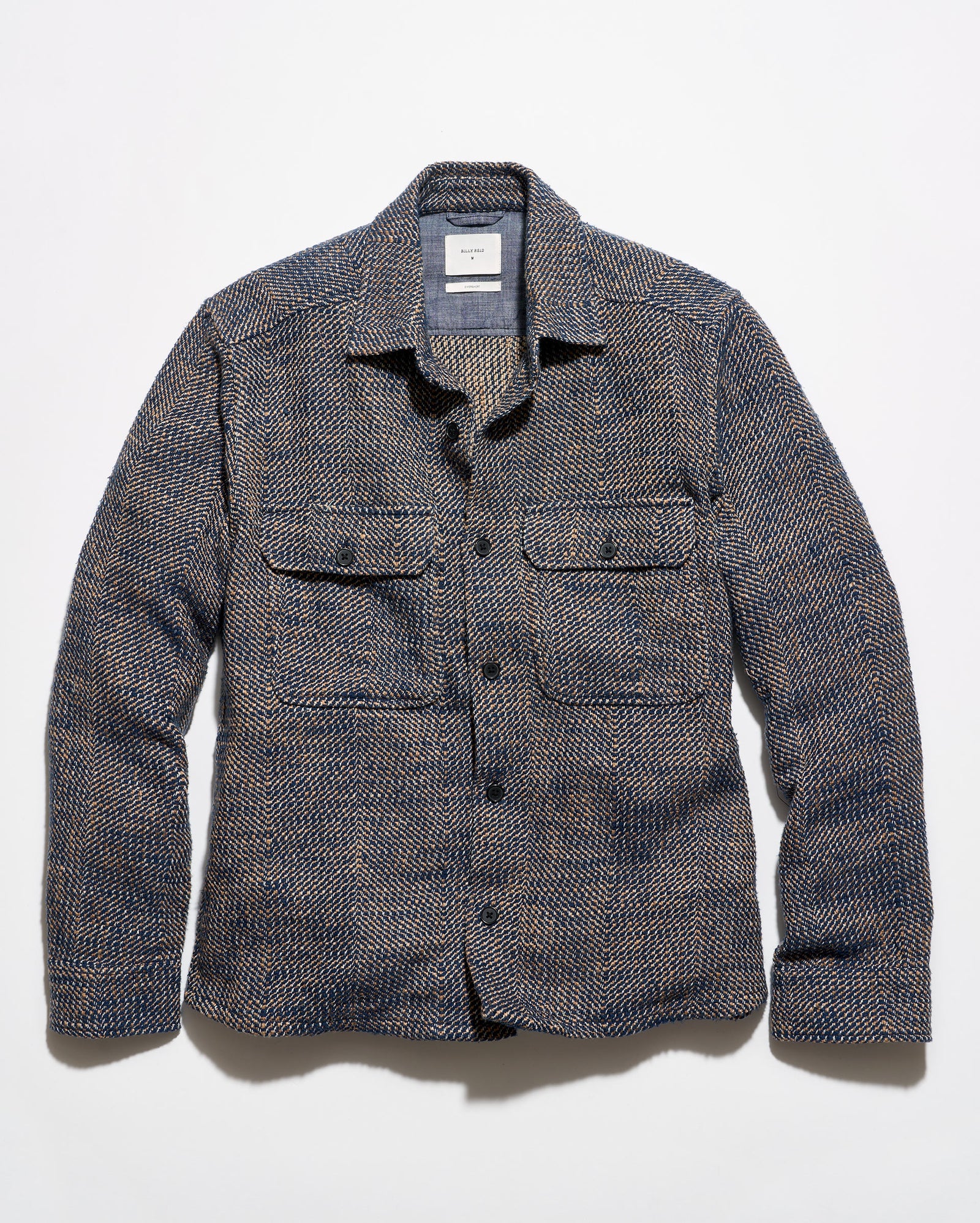 Blue and brown overshirt on a grey background.