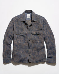 Blue and brown overshirt on a grey background.