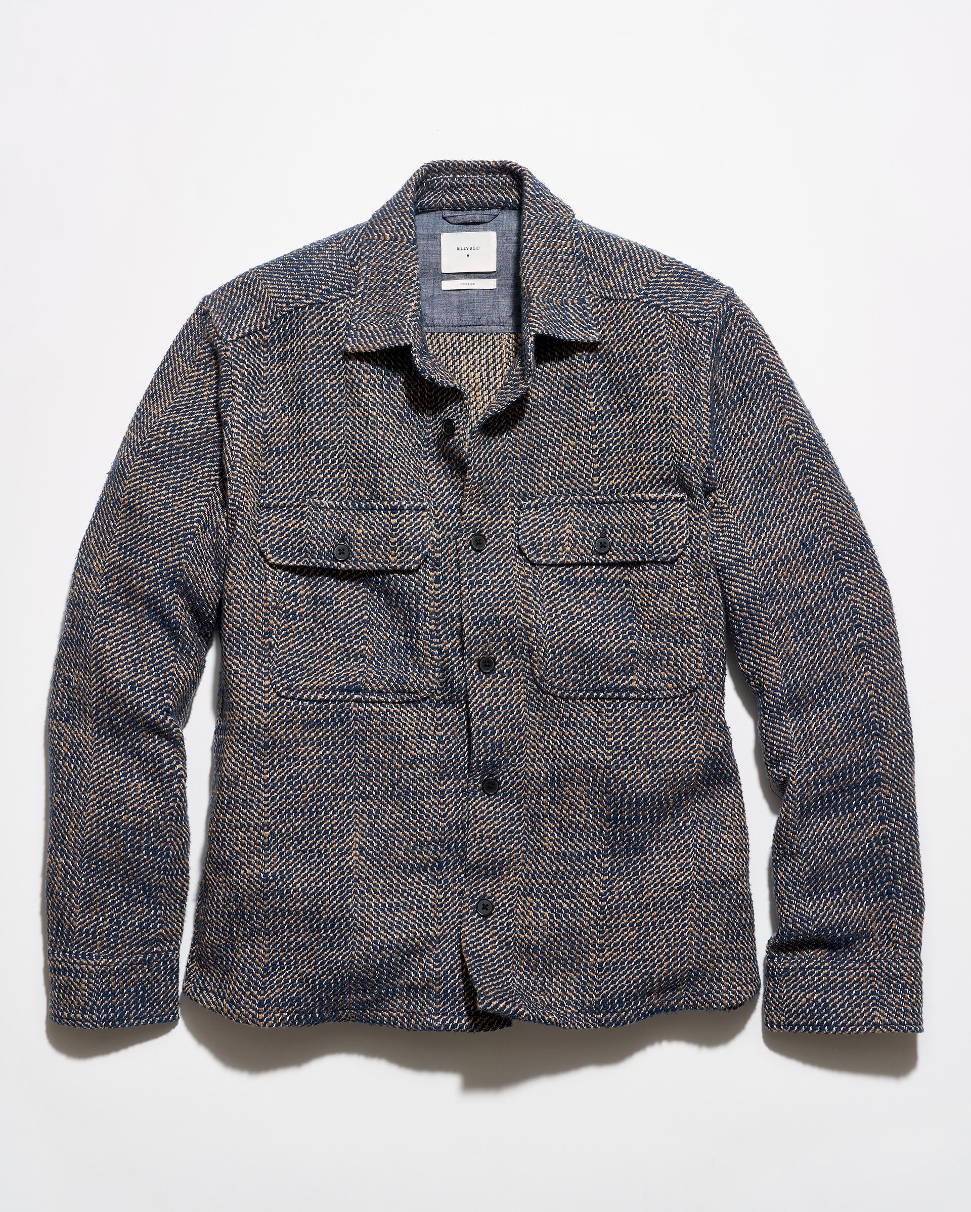Blue and brown overshirt on a grey background.