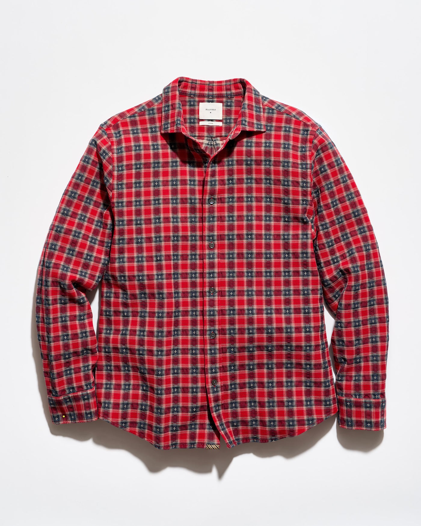 A red and black plaid long-sleeve button-up shirt laid flat against a white background.