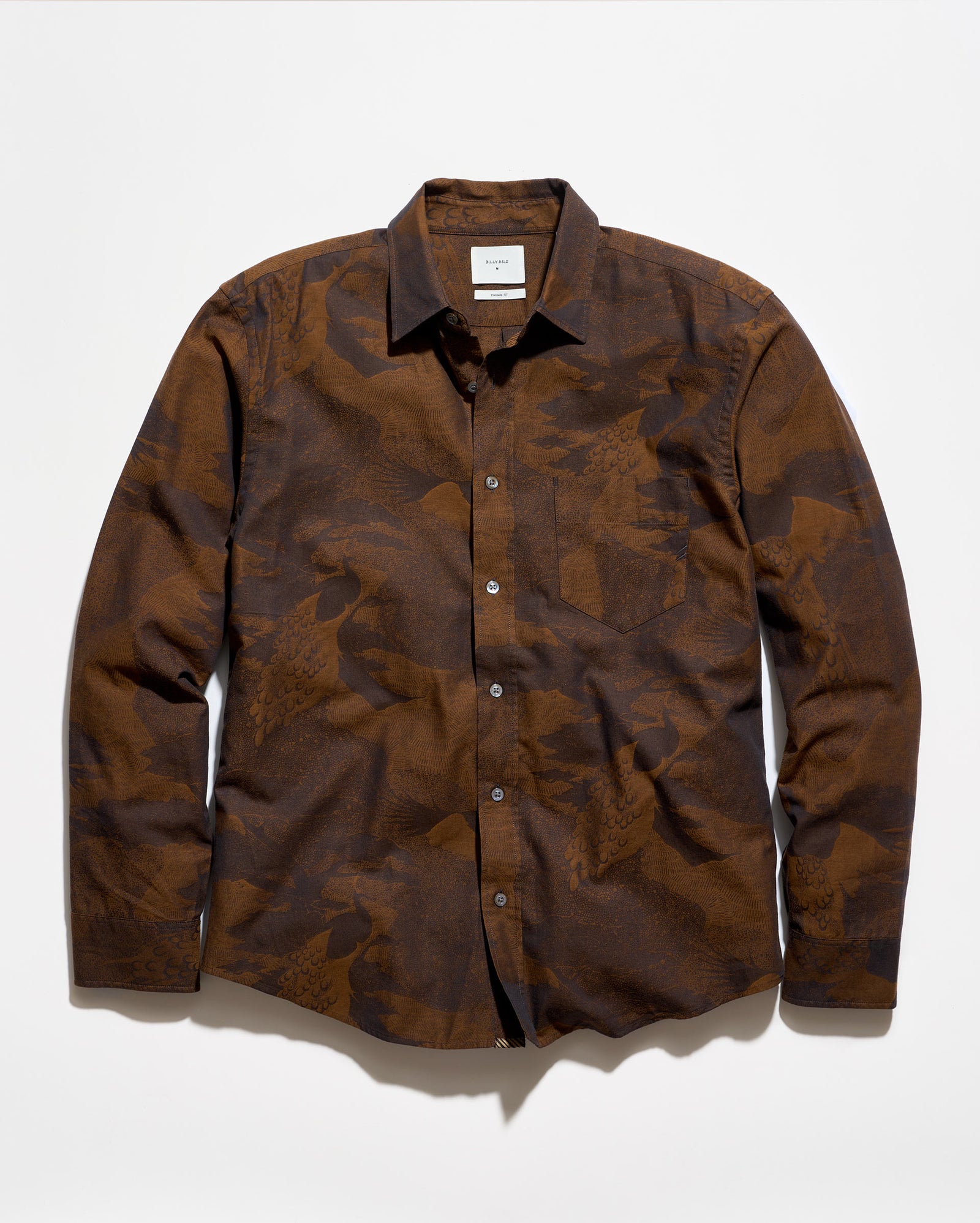 A long-sleeve button-up shirt with a brown and dark brown abstract camouflage pattern, laid flat against a white background.