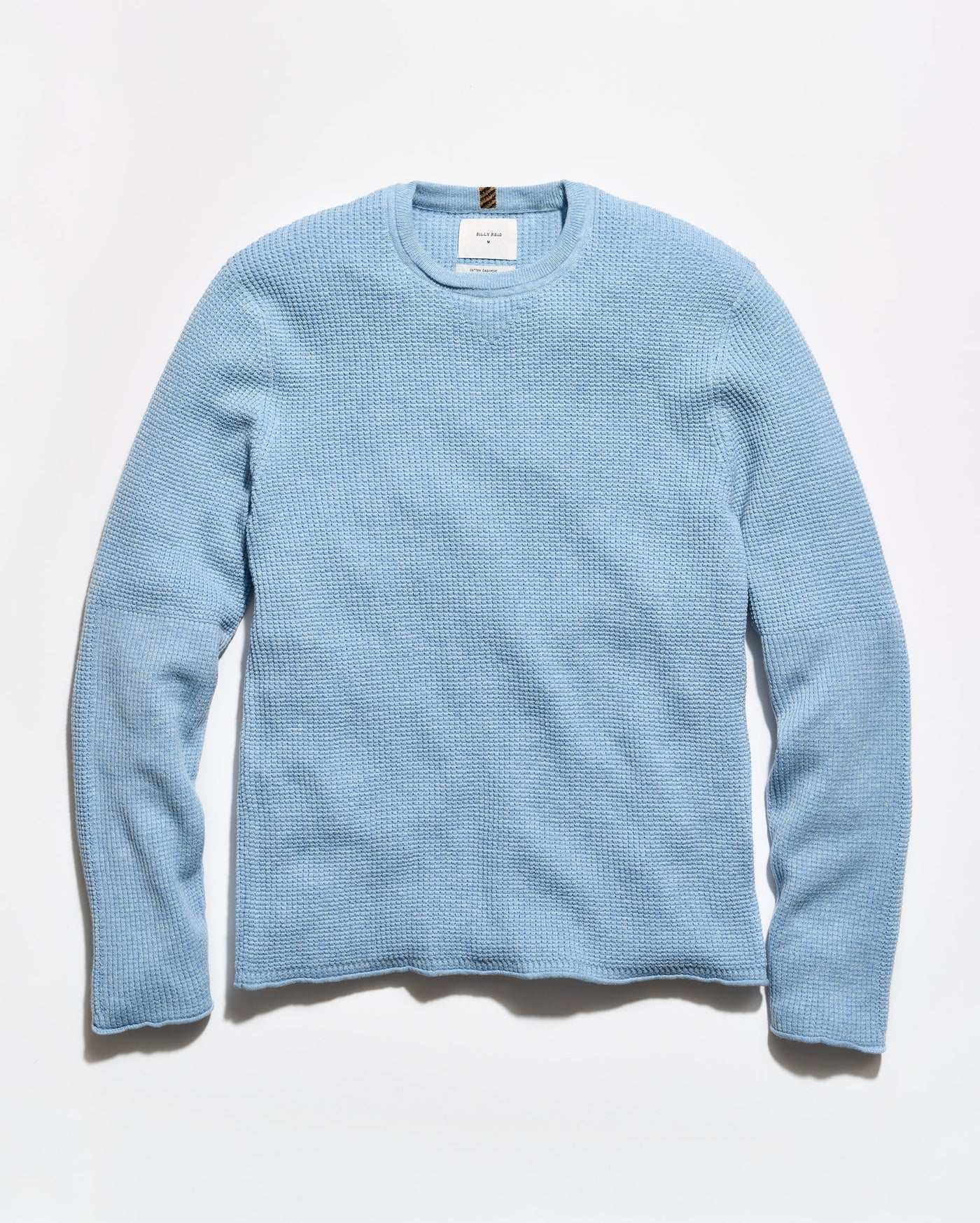 A light blue textured knit crewneck sweater with long sleeves, laid flat against a clean white background.