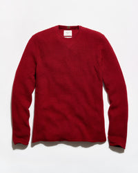 A red waffle-knit crewneck sweater laid flat against a white background.