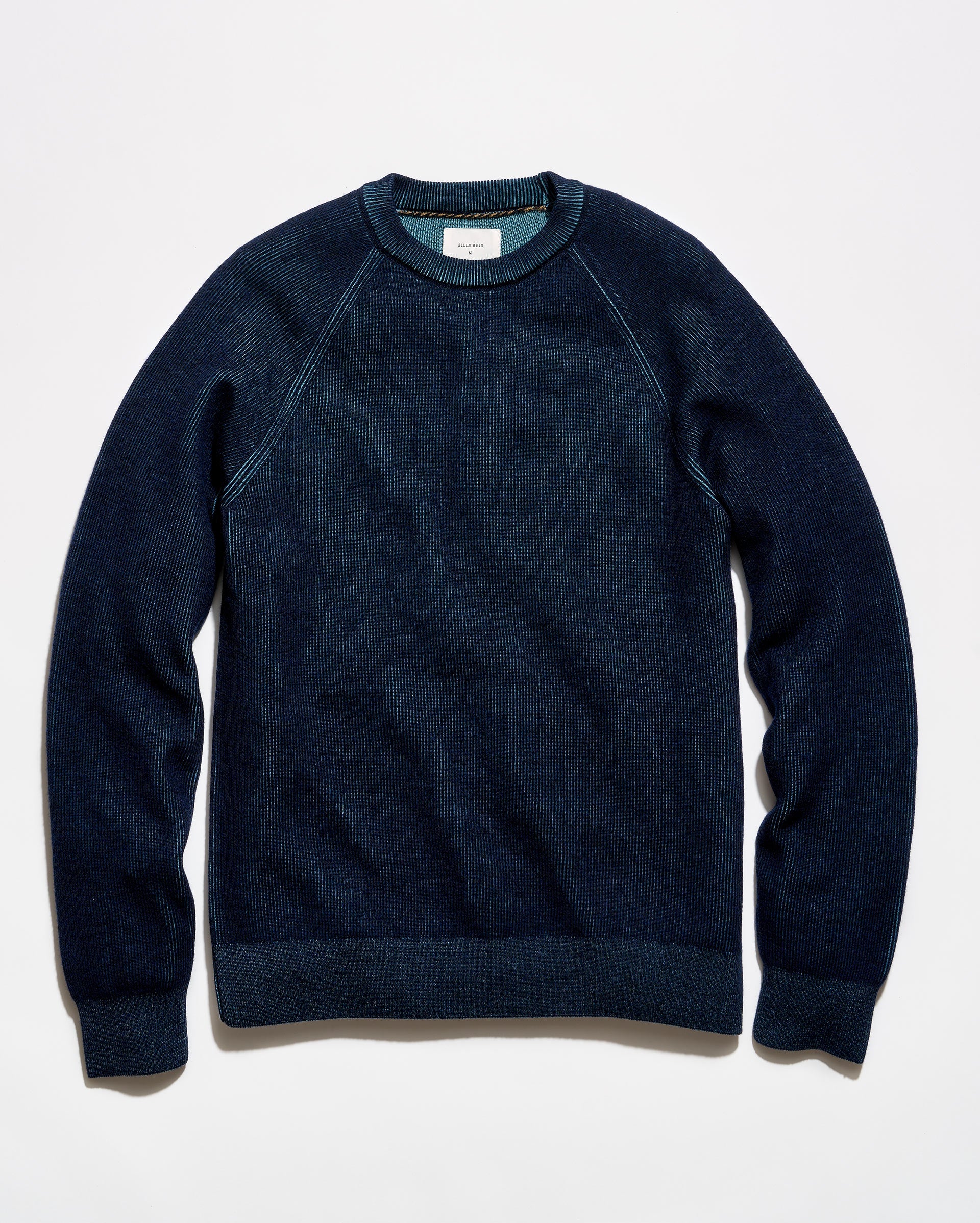 A dark navy blue crewneck sweater with raglan sleeves, laid flat against a clean white background.