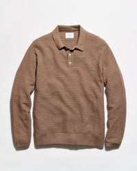 A brown textured knit polo sweater with a collar and two-button placket, laid flat against a clean white background.