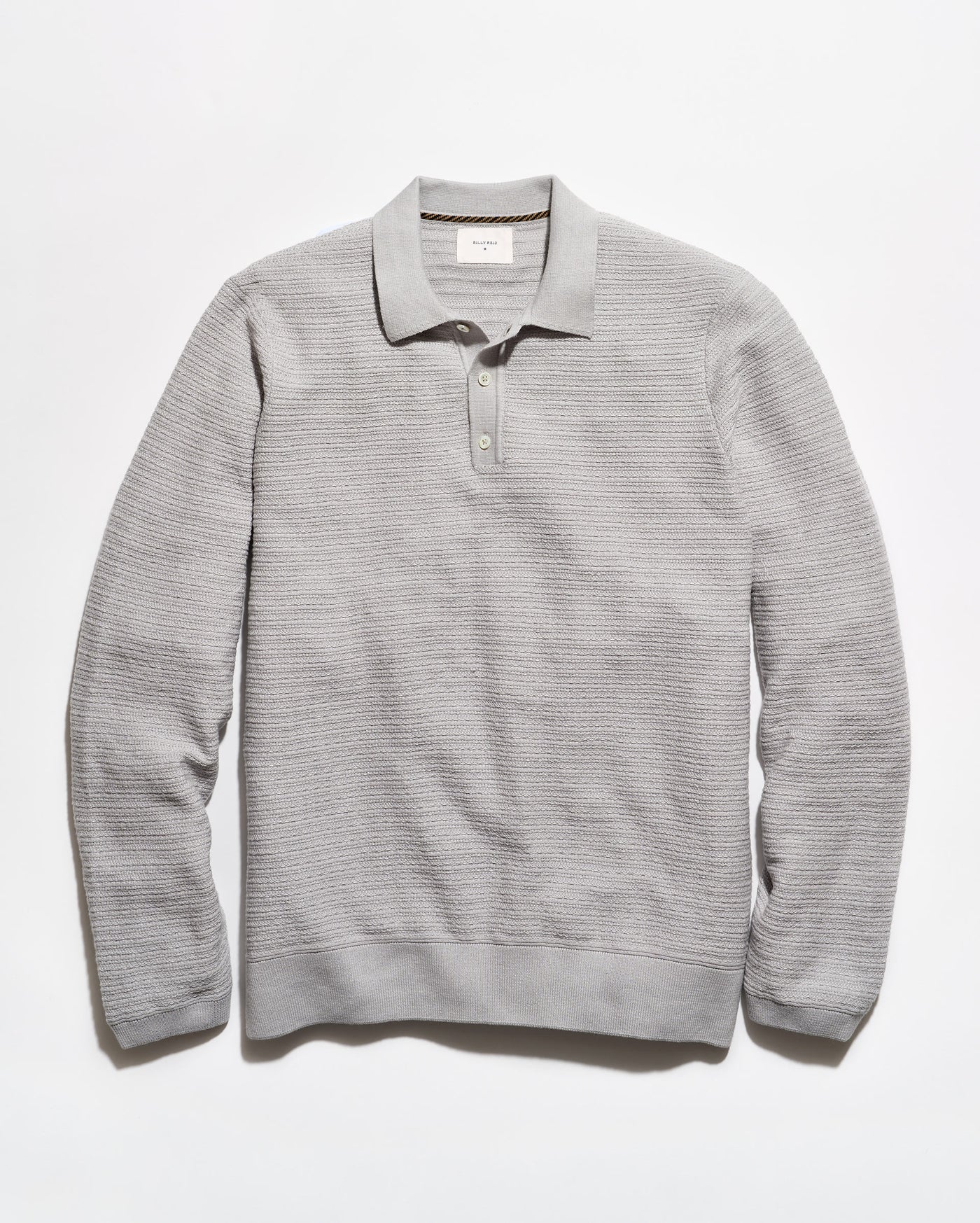 A light gray ribbed knit polo sweater with a collar and three-button placket, laid flat against a white background.
