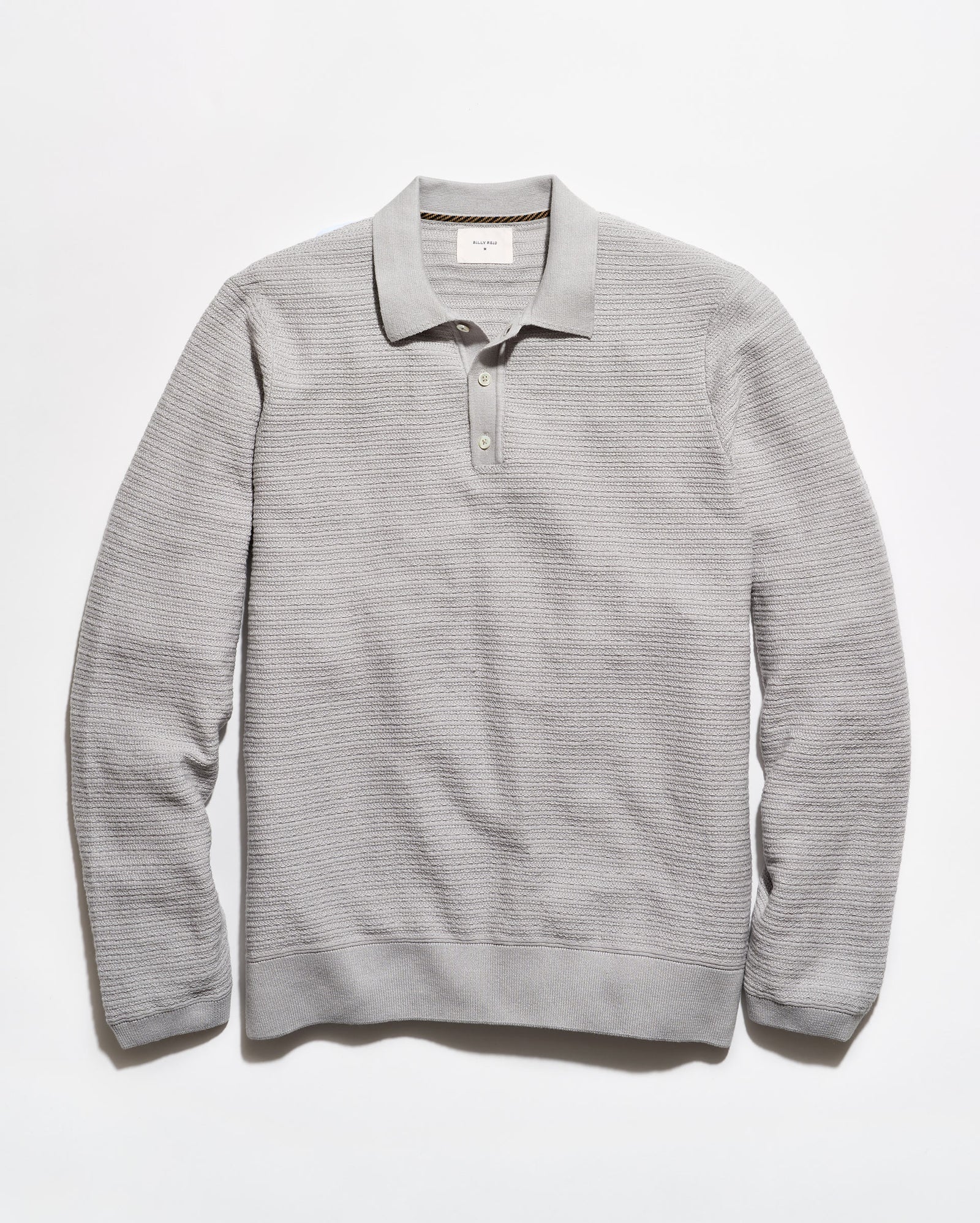 A light gray ribbed knit polo sweater with a collar and three-button placket, laid flat against a white background.