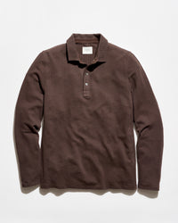 A dark brown ribbed long-sleeve polo shirt with a three-button placket, laid flat against a light off-white background.