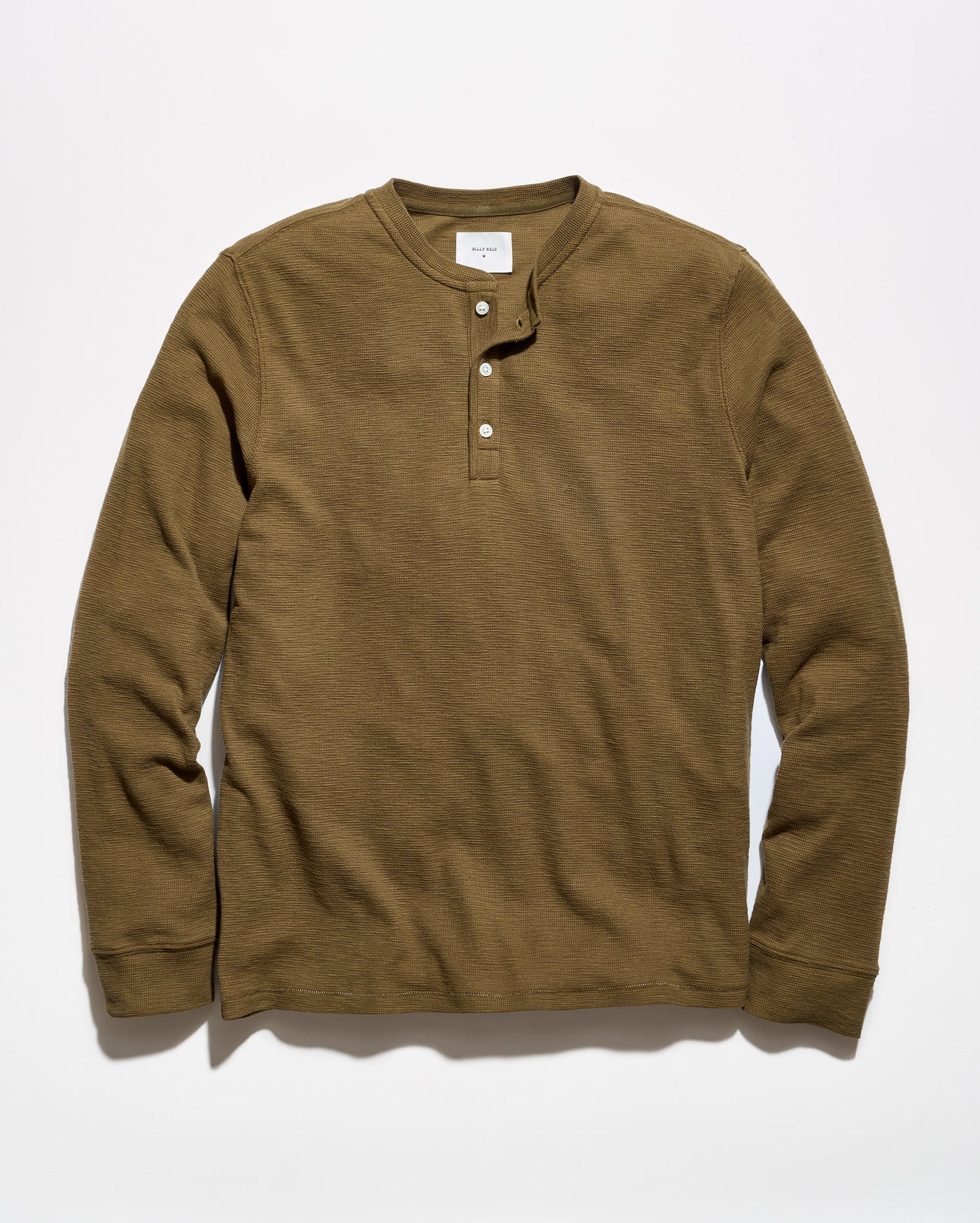 A brown long-sleeve henley shirt with a three-button placket, laid flat against a light gray background.
