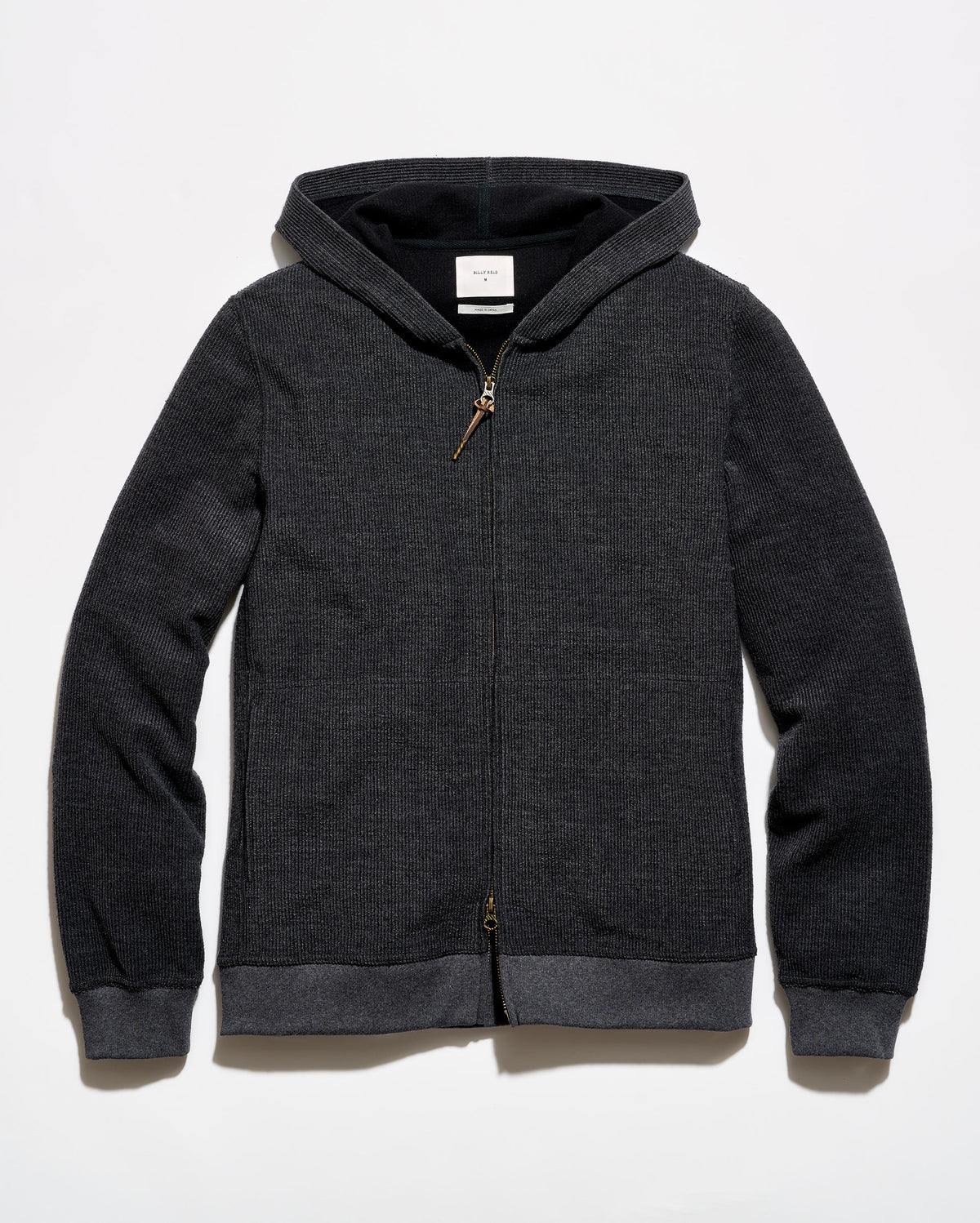 A dark gray heather zip-up hoodie with a black interior hood lining and contrasting dark gray ribbed cuffs and hem, shown flat on a light gray background.