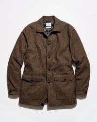 A brown textured tweed jacket with a button-up front, collar, and two front flap pockets, laid flat against a white background.