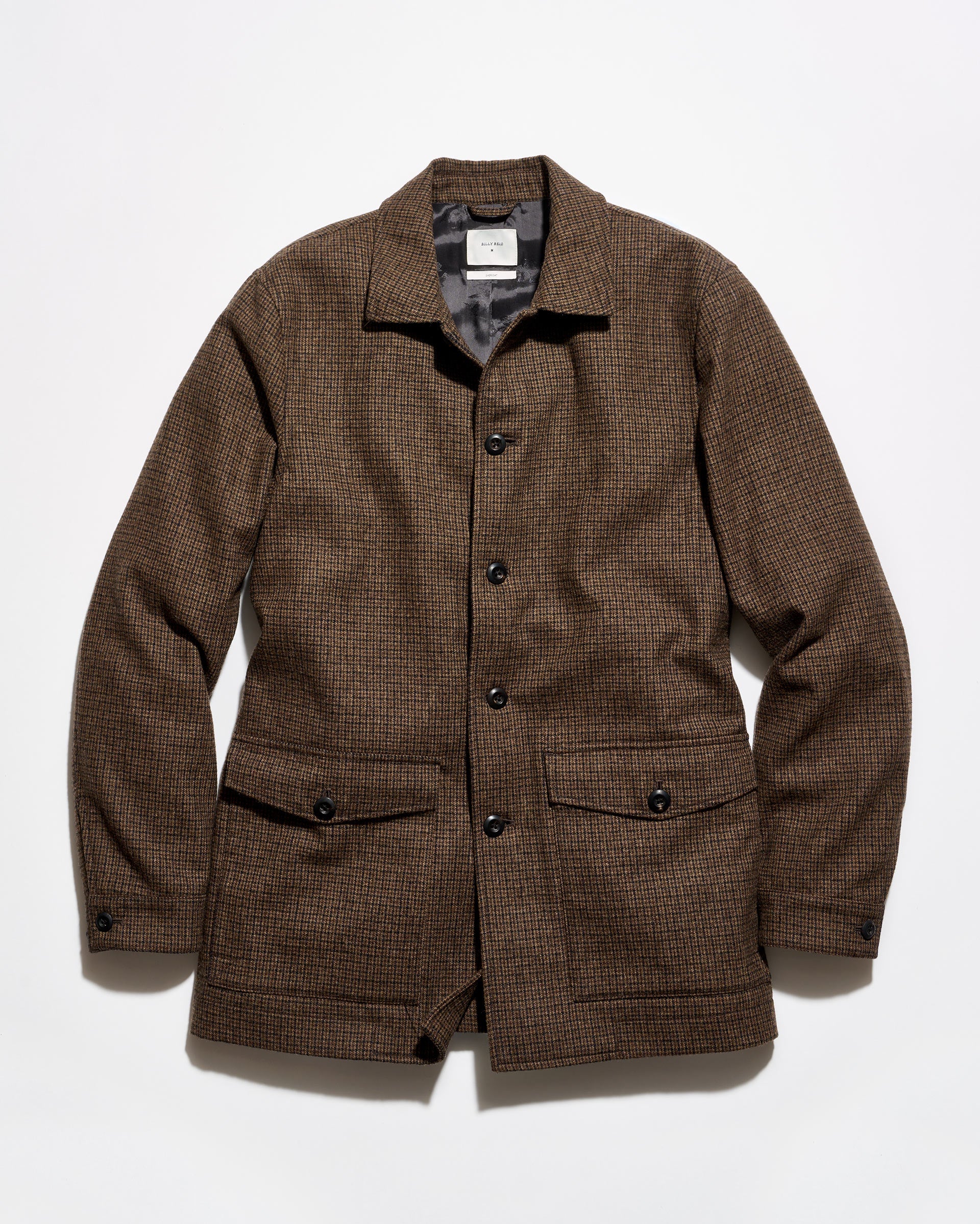 A brown textured tweed jacket with a button-up front, collar, and two front flap pockets, laid flat against a white background.