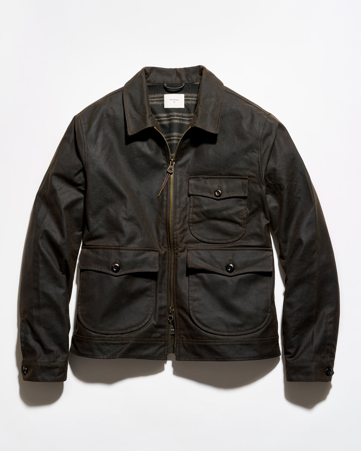 A dark brown waxed canvas utility jacket with a front zipper, two chest flap pockets, and two large lower hand-warmer pockets, laid flat against a white background.