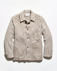 A light beige corduroy utility jacket with a pointed collar, button front, and three front pockets, displayed flat against a white background.