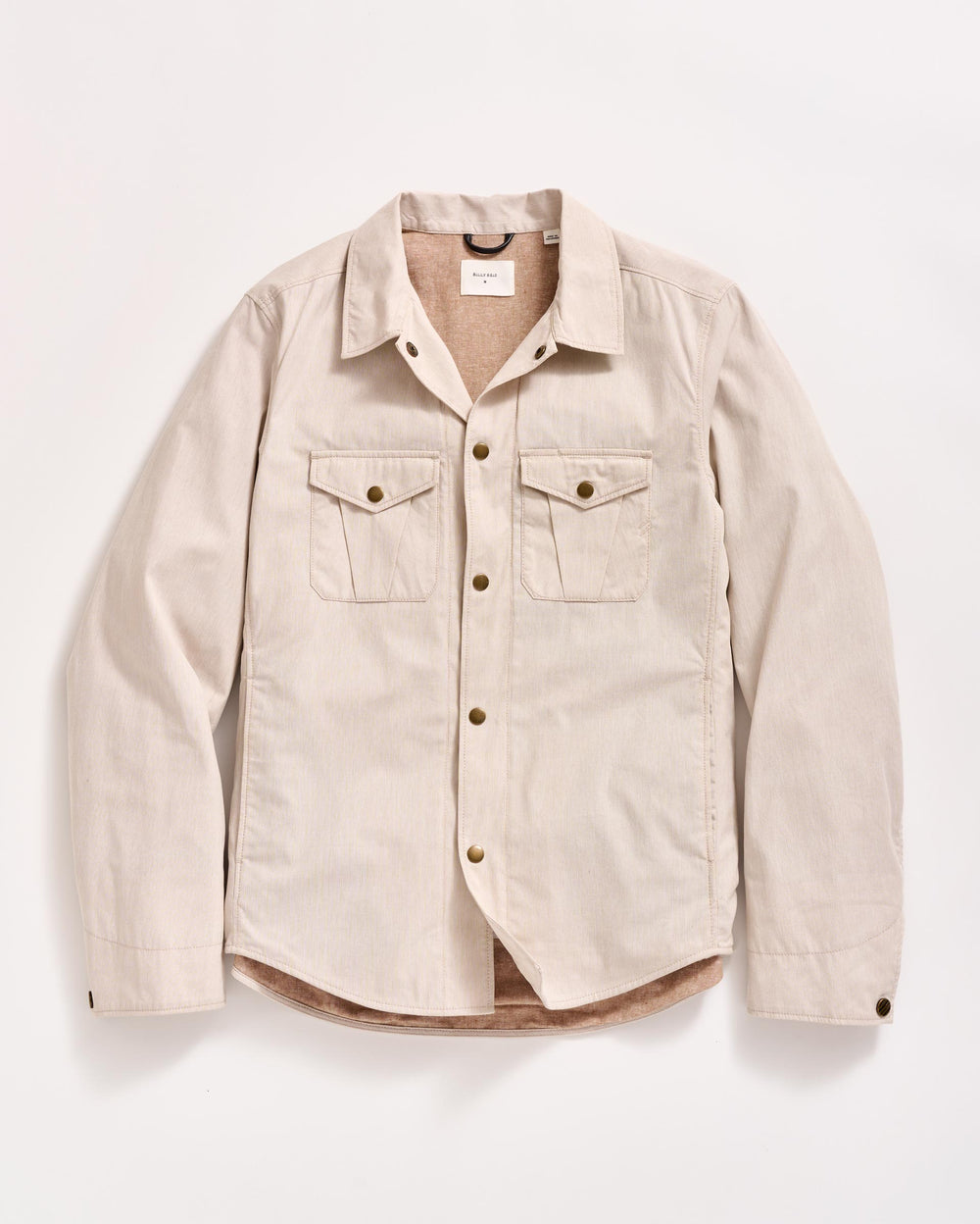 A beige, long-sleeve button-up shirt with two chest pockets and brown buttons, laid flat on a white background.