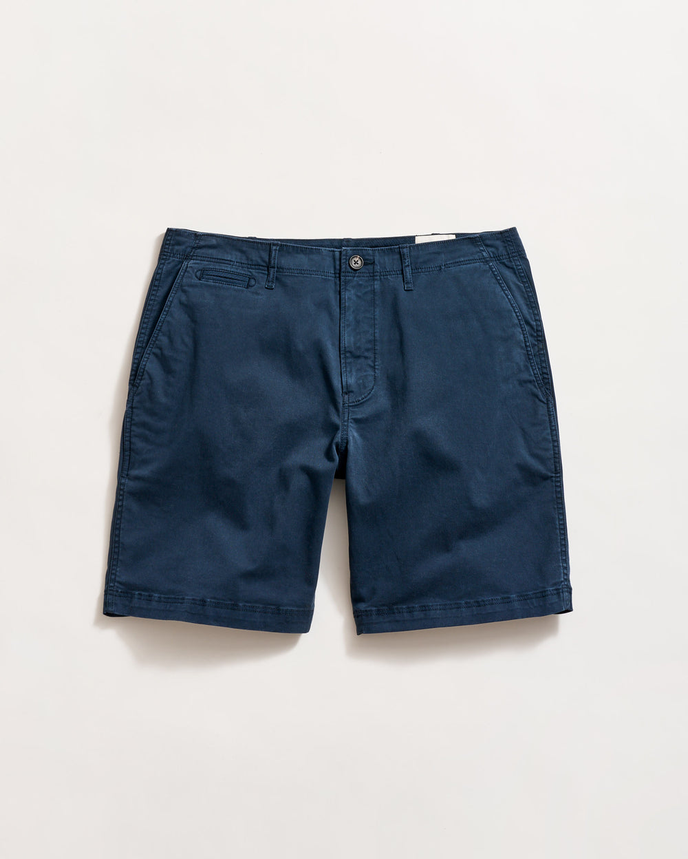A pair of navy blue chino shorts with side pockets, a small coin pocket on the right, and a button closure, laid flat on a white background.