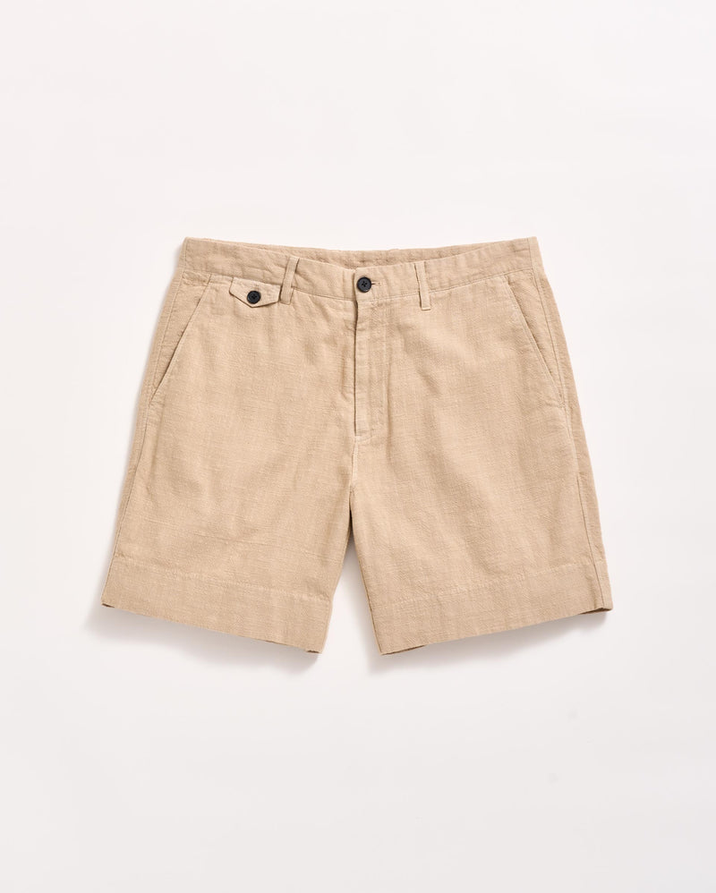 A pair of beige linen shorts with side pockets, belt loops, and a front button and zipper closure, displayed flat on a white background.