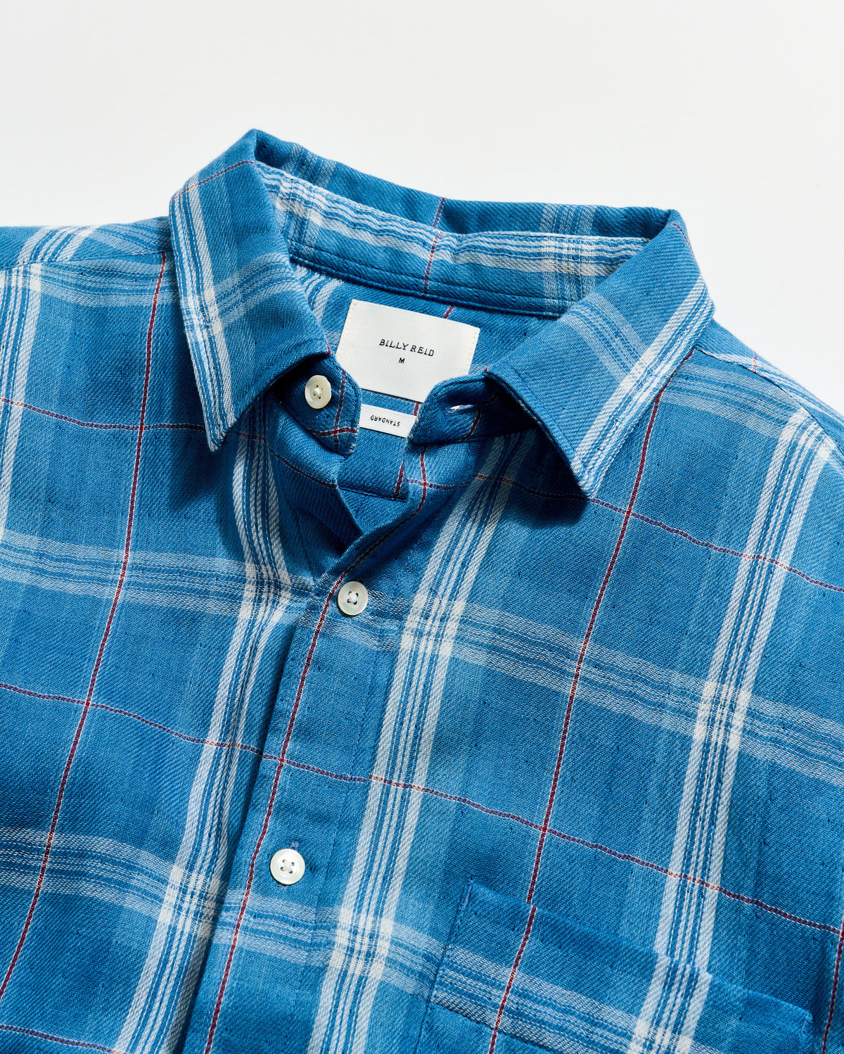 Blue plaid shirt with collar and buttons on a white background