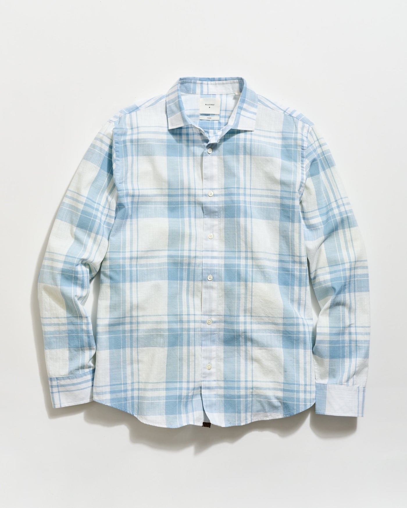 Blue and white plaid shirt on a light gray background