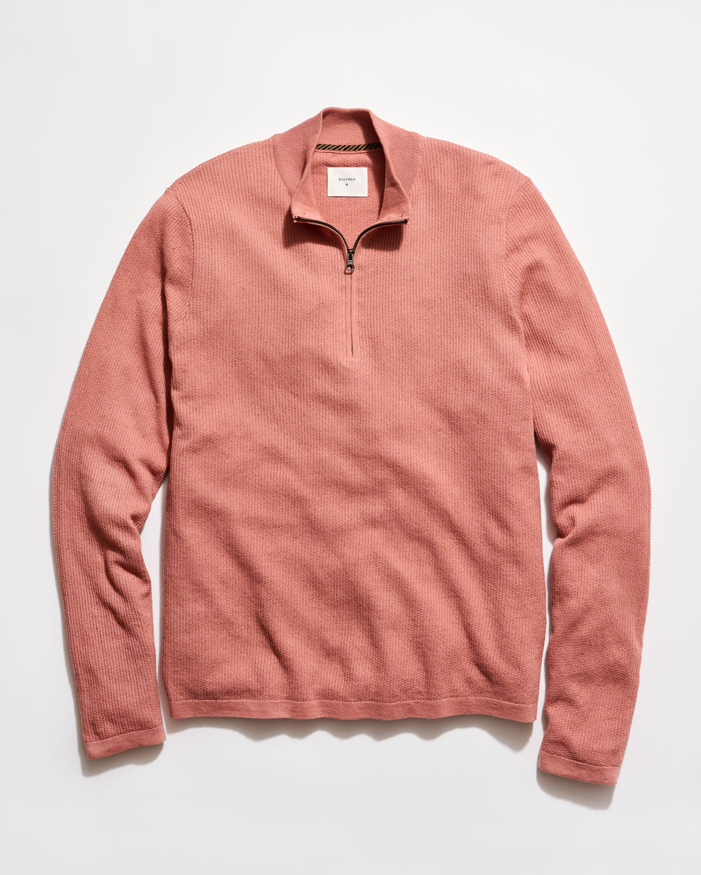 Pink long-sleeve shirt with a quarter zip on a white background
