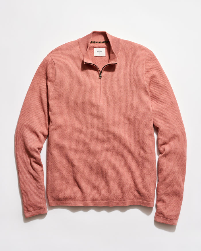 Pink long-sleeve shirt with a quarter zip on a white background