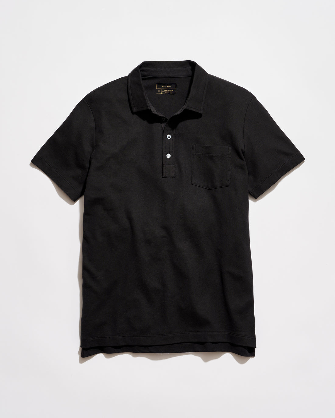 Black polo shirt on a light gray background