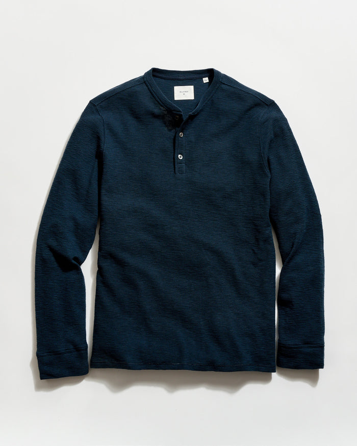 Navy long-sleeve henley shirt on a light gray background